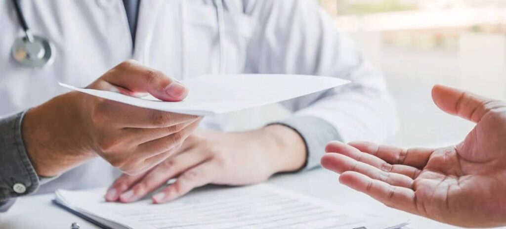 Doctor handing medical bill to patient during hospital visit